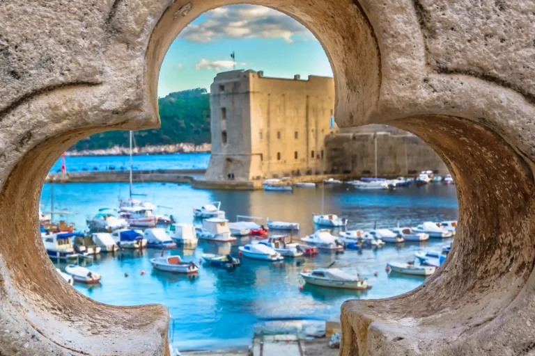 old stone hole with dubrovnik scenery in background